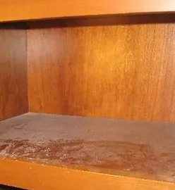 a shelf with a dust build up